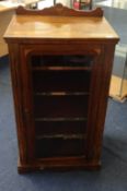 A Victorian walnut and inlaid music cabinet with single glazed door