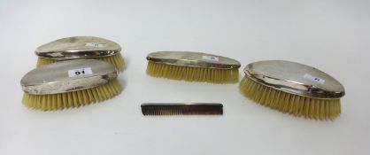 Four silver backed clothes brushes and a comb