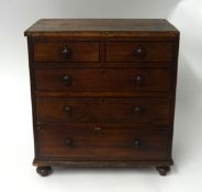 A miniature 19th century chest fitted with two short and three long drawers on turned feet