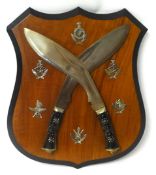A shield with a pair of Gurkha knives and insignia