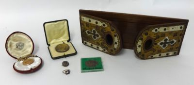 A ecclesiastical book slide, some general jewellery, a gilt watch chain, Commerative medal etc