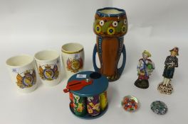 Three Commerative beakers, two figurines, novelty tinplate money bank, Art pottery vase and two