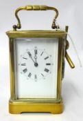 A carriage clock in brass case, 18cm (handle up) with striking movement and platform escapement, the