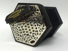 A Wheatstone Concertina with forty five metal buttons with steel pierced ends, six fold bellows, (