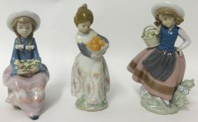 Three Lladro figure depicting two girls with baskets of flowers, one with fruit (3)