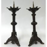 A pair of metal candlesticks, 37cm