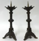 A pair of metal candlesticks, 37cm