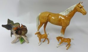 A Beswick palomino hunter horse, two Beswick foals t/w a Goebal bird group 'Robin with Young Cuckoo'