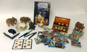 Mixed lot including a boxed set of dominoes, wood carvings, Star Wars movie cards, novelty bell,