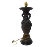 A bronze table lamp decorated in relief with flowers and branches, wired for an electric lamp,