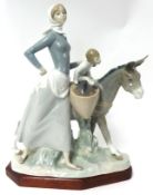 A large Lladro figure, 'Mother child and Donkey' on stand , 37cm