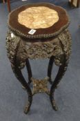 A carved hardwood jardinière stand of Chinese design inlaid with pink marble, 92cm high