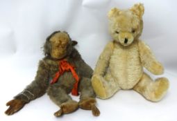 An old teddy bear and soft toy monkey