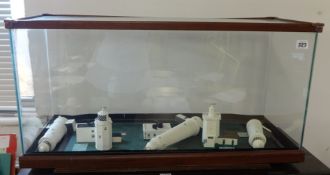 Five marble lighthouses in glass display case measuring 40cm x 76cm