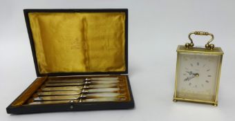 A modern brass cased carriage clock also a cased set of mother of pearl handle cake knives in Mappin