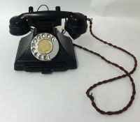 An old black bakelite telephone, handle stamped GPO No 186