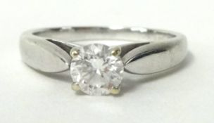 A diamond solitaire ring set in white gold with Canadian diamond certificate indicating a round