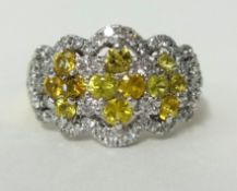 An impressive yellow sapphire and diamond cluster ring, stamped 18k, .750, ring size, O.