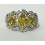 An impressive yellow sapphire and diamond cluster ring, stamped 18k, .750, ring size, O.