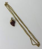 A 9ct pendant with stylised grapevine design set with rubies in 9ct gold chain.