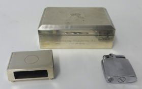 Silver match holder, silver cigarette box and lighter.