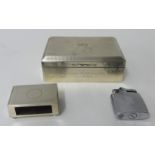 Silver match holder, silver cigarette box and lighter.