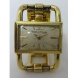 An 18ct gold Ladies Jaeger Le Coulter mechanical wrist watch, set on a 9ct gold bracelet, gross