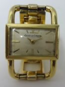An 18ct gold Ladies Jaeger Le Coulter mechanical wrist watch, set on a 9ct gold bracelet, gross