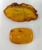 Two large amber brooches (2).