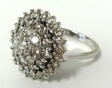 An impressive diamond four tier cluster ring set in 18ct white gold, ring size, P.