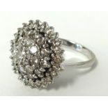 An impressive diamond four tier cluster ring set in 18ct white gold, ring size, P.