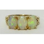 An opal three stone ring set in 14K yellow gold, ring size N.