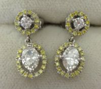 A pair of natural yellow and white diamond earrings