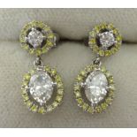 A pair of natural yellow and white diamond earrings