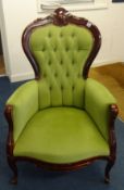 A reproduction Victorian upholstered and button back armchair.