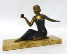 An Art Deco sculpture, a seated lady holding a ball, mounted on a marble plinth, width 24cm.