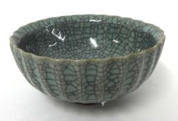 Chinese crackle glaze shallow fluted bowl with seal mark to base and crimped edge.