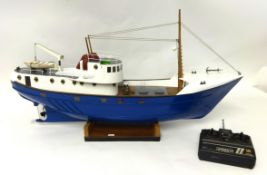 A fibreglass remote control fishing boat, 90cm