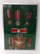 A framed mixed collection of medals including two WWII, a German Cross, 1914/15 Star etc.