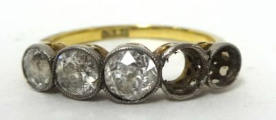 An antique 18ct five stone ring set with three diamonds, a loose diamond and one zircon, size Q, the