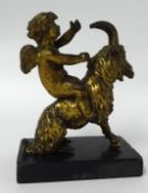A 19th century gilt bronze figure, a winged cherub upon a ram on a plinth.18cm high including base.