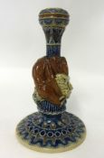 A Martin Brothers pottery candlestick with hound and rabbits, damaged, incised mark, R.W.Martin,
