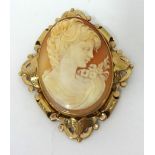 A large antique cameo brooch set in an ornate yellow metal mount, 6.50cm x 5cm, with purchase
