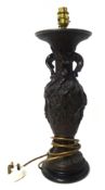 A bronze table lamp decorated in relief with flowers and branches, wired for an electric lamp,