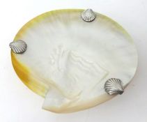 A mother of pearl shell dish with silver plated scallop mounts.