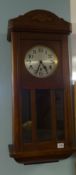 A 1930's oak wall clock.