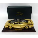 A Maisto gold plated Jaguar XJ220 1:18th scale. original box and certificate