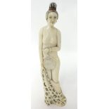 Carved Japanese ivory figure of a nude Lady holding a removable fan, 22cm.