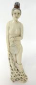 Carved Japanese ivory figure of a nude Lady holding a removable fan, 22cm.