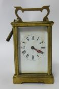 A brass cased carriage clock with key, 15cm tall